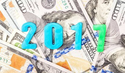 Plastic numbers 2017 on money. New year 2017 and business concep