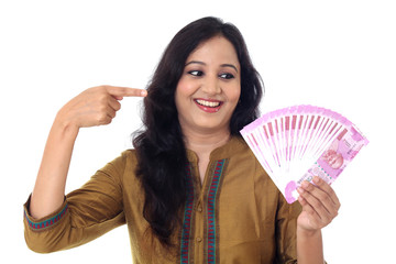 Young woman showing newly introduced two thousand rupee notes