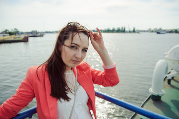 Fototapeta premium Young woman sailing on cruise liner or ferry with sea