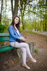 beautiful girl in a dress in the spring in a mask of dry leaf