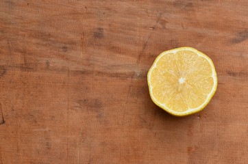 Fototapeta na wymiar Lemon half on rustic wood