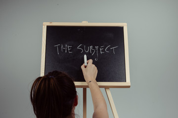 subject written in white chalk on a black chalkboard
