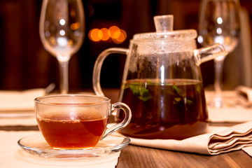 Glass teapot and glass tea Cup with fruit tea and mint.