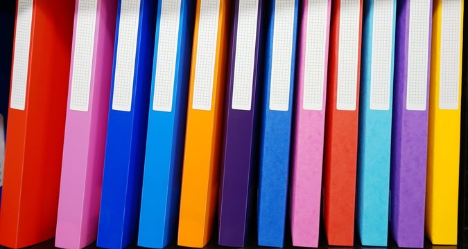Colorful binders on a shelf