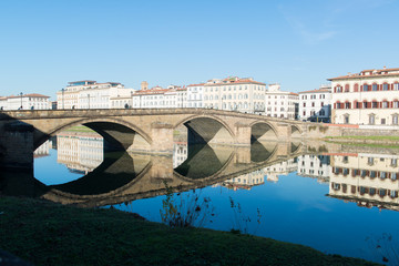 Fototapeta na wymiar View of Arno river embankment with architecture and buildings a