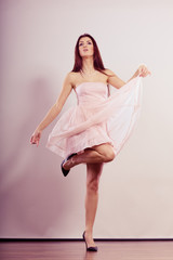 Fototapeta premium woman in bright dress and high heels shoes dancing