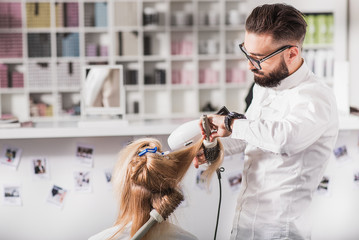 Calm male stylist is doing his job