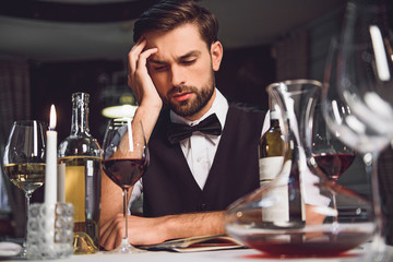 Man looking at wine with lost sight