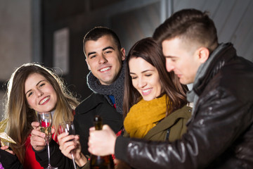 Happy young friends having fun outdoors on New Year's eve