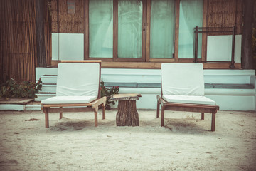 Fototapeta na wymiar retro chairs and resort near sea