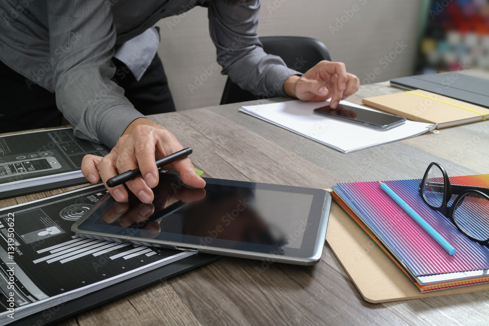 Aufkleber website designer holding smart phone and working computer digita