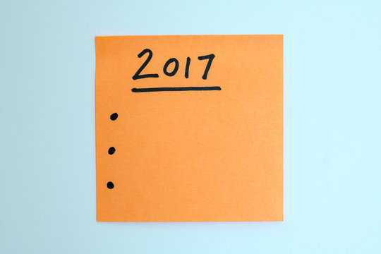 orange note with a to do list for the new year