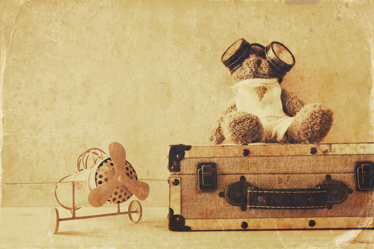 Photo of vintage toy plane and cute teddy bear