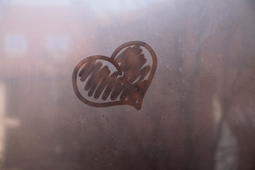 Heart symbol of love drawn on the glass