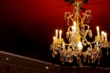 Beautiful crystal chandelier on black ceiling
