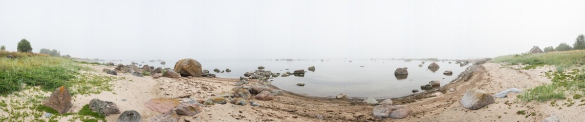 Rocky beach and morning fog in summer. Sea, mist, coast, forest, seaside natural environment. Shore in Koipsi Island, Estonia, Europe. 360 .degrees panorama.