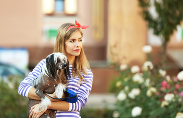 Naklejka na ściany i meble Beautiful young woman with her dog outdoors