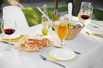Table with food and drinks served for picnic