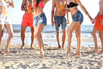 Dancing people legs on beach