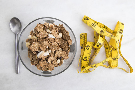 bowl of cereal with measuring tape, concept of slimming and healthy diet