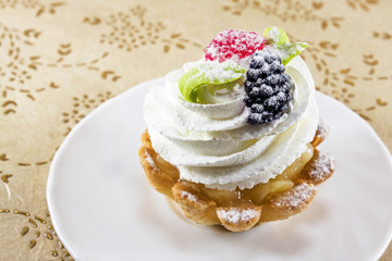mini cake with cream on the dish