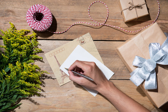 Christmas decorated gift box over wooden background. View from a