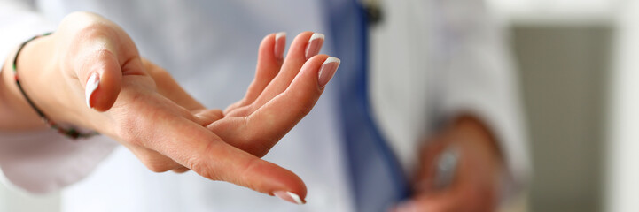 Female medicine doctor offering helping hand closeup