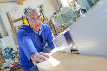 old carpenter working with wood