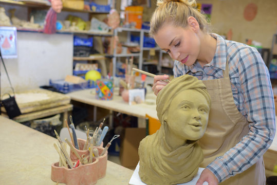 Female artist sculpting