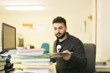 Bearded office clerk working with files