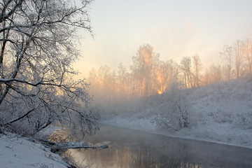 The sun's rays in a frosty morning on the river