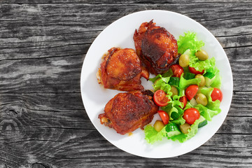grilled  chicken thighs with fresh salad, view from above