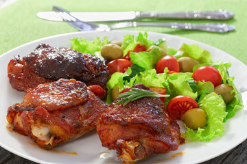 tasty grilled chicken thighs with green fresh salad