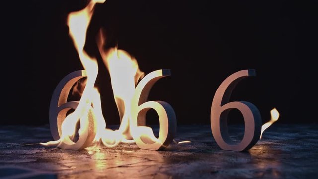 4k shoot of a creative composition with 666 numbers on fire