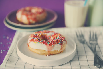 Tasty doughnut and glass of milk on the table