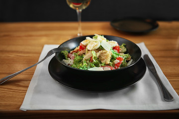 Plate with delicious salad on served table in cafe