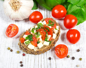 Ciabatta bread with tomatoes, mozzarella and basil.