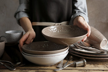 Female hands holding ceramic dishware, closeup