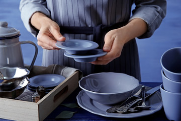 Fototapeta na wymiar Closeup of female hands holding saucers