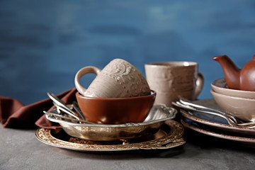 Brown dishware on table and colour background