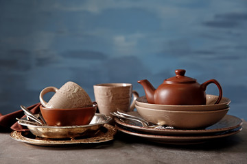 Brown dishware on table and colour background