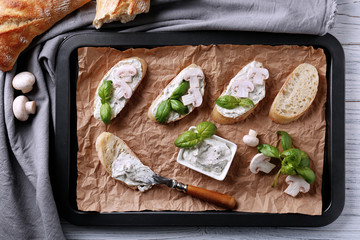 Tasty bruschetta with creamy cheese on baking tray © Africa Studio