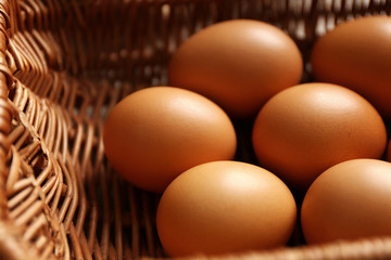 Raw eggs in basket, closeup
