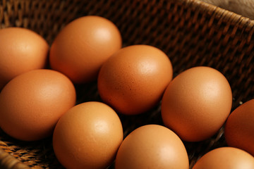 Raw eggs in basket, closeup