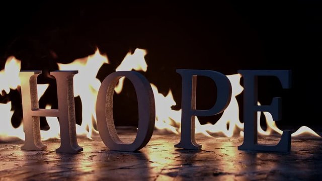 4k shoot of a creative composition with word hope on fire