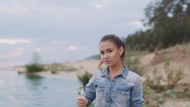 Beautiful girl walking along the shore