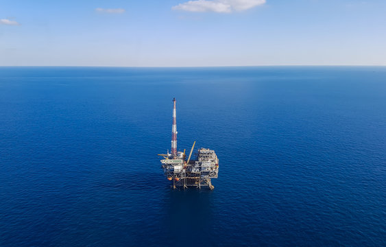 Image of oil platform while cloudless day - aerial view