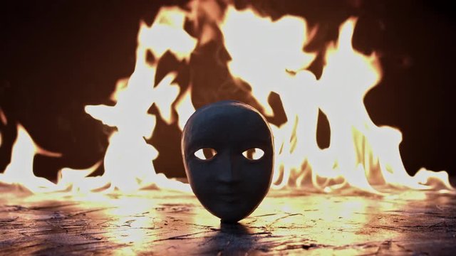 4k shoot of a creative composition with a mask on fire