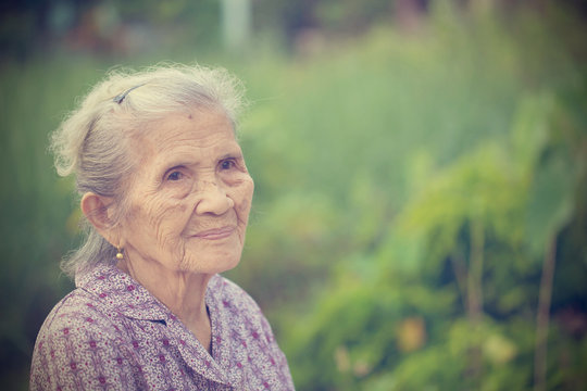 Portrait of a cheerful asian senior woman. vintage tone.
