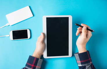 Man using a white tablet at the office